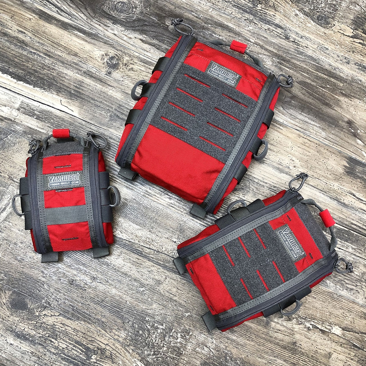 Three bags of luggage sitting on a wooden floor.
