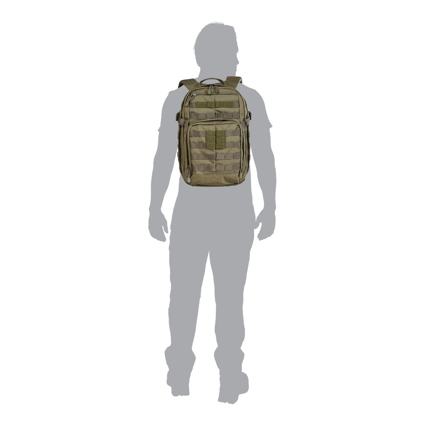 A person wearing a backpack with many compartments.