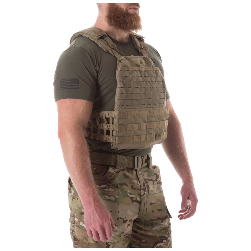 A man wearing an army vest and shirt.
