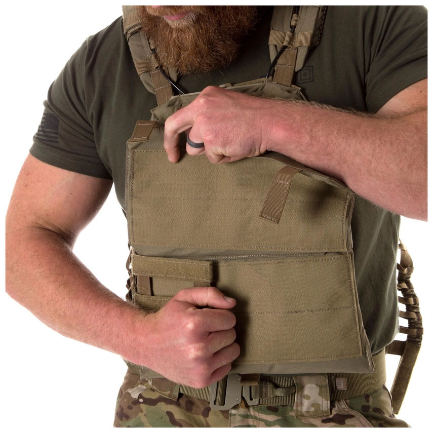 A man in an apron is holding something
