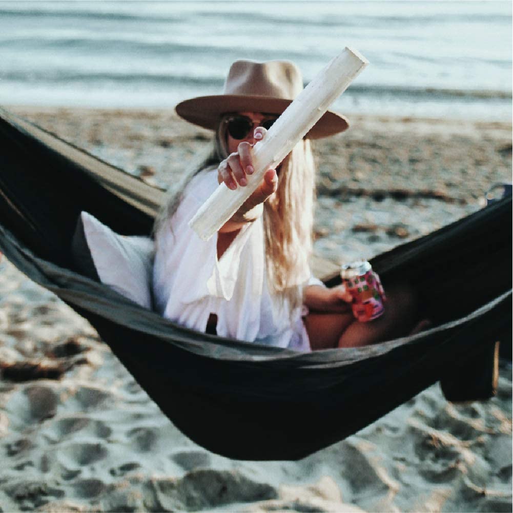 A person in a hammock on the beach